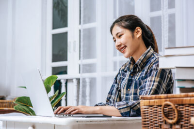 Woman using laptop sitting in ergo chair