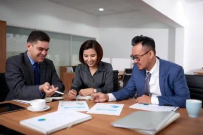 meeting desk, Three professionals in the office collaborating for work using meeting desk.