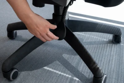 A hand checking adjustable features of an office chair singapore.