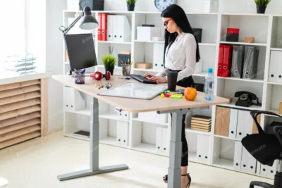Woman working at Adjustable Tables in a modern office.